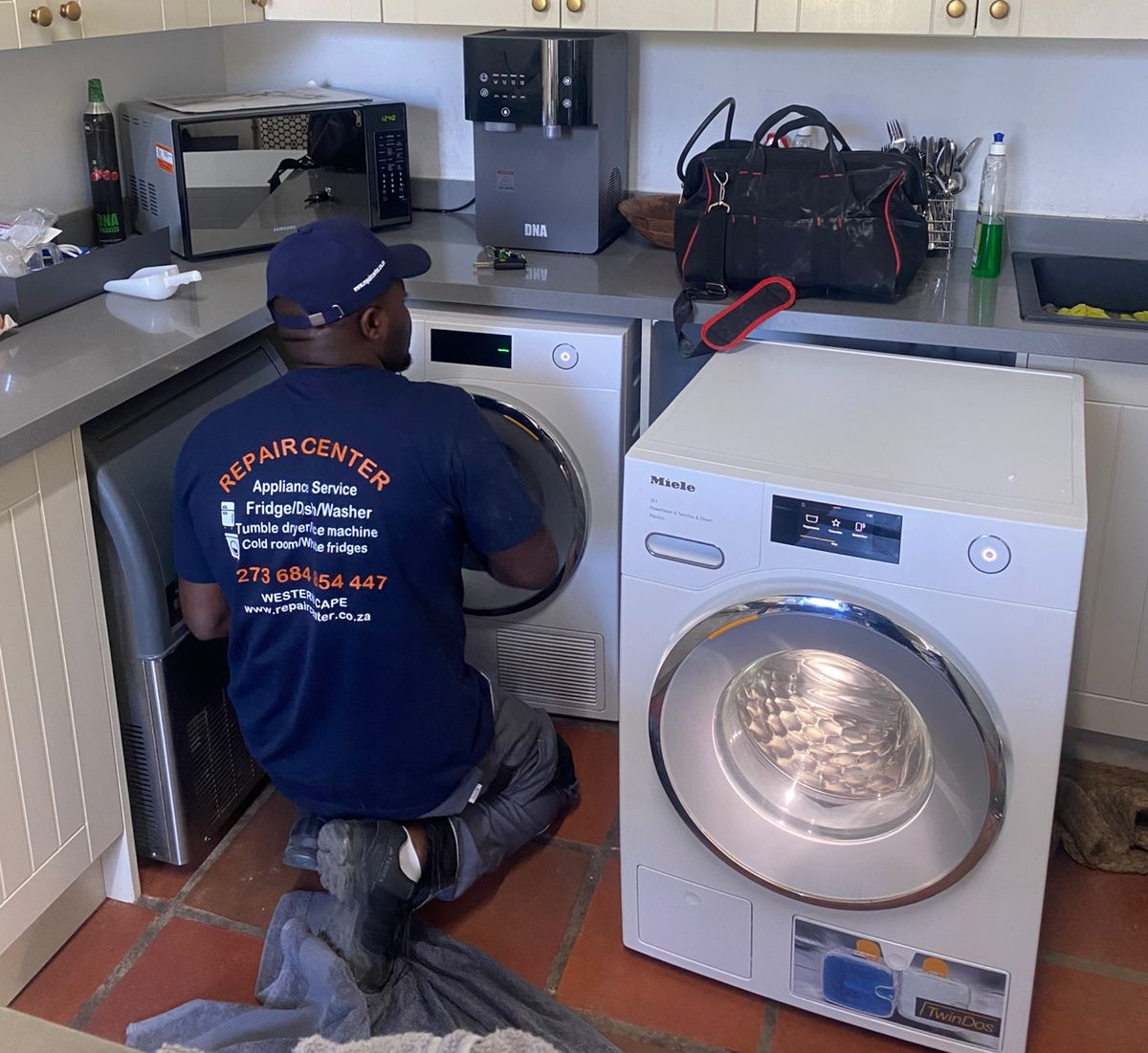 Technician performing appliance repair in Cape Town